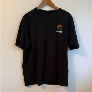 Preowned Men’s Size XL Black The Nike Tee. Has a back graphic and front patch